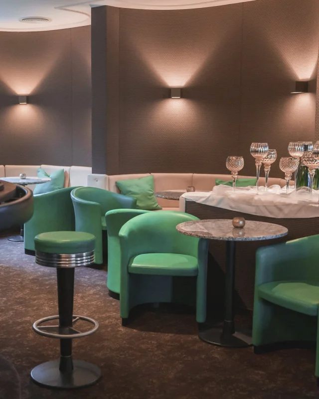 Hotel lounge bar with upholstered seating, unoccupied