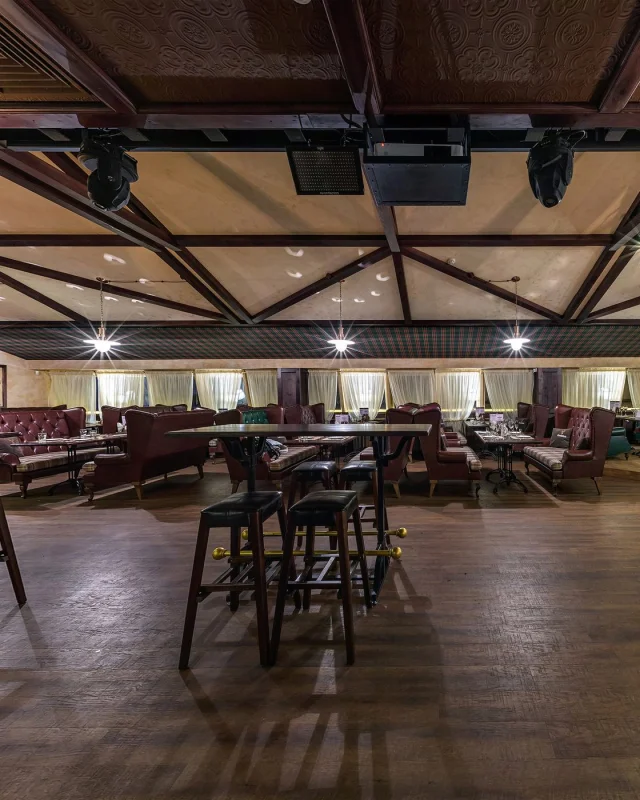 Larger venue interior with a dance floor, lit and empty
