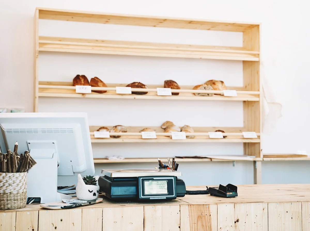 Bakery counter and till with the display shelves behind it