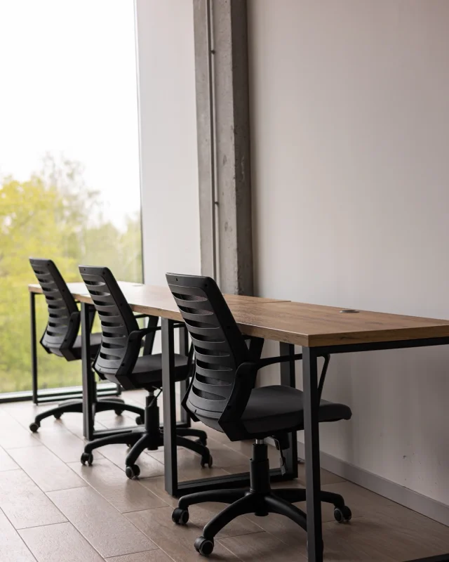 Empty office with desks and chairs, unoccupied
