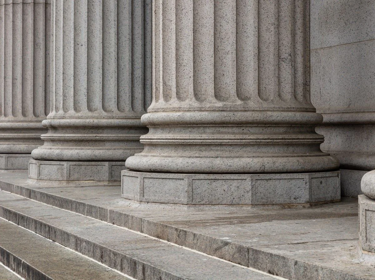 Stack of bound legal case files on a courtroom bench