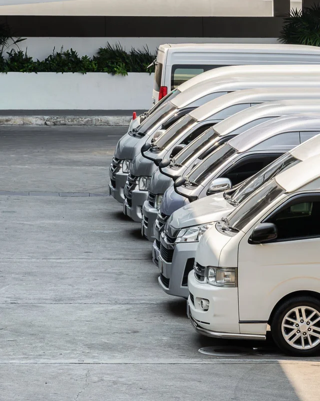 Row of commercial vehicles parked in a depot yard