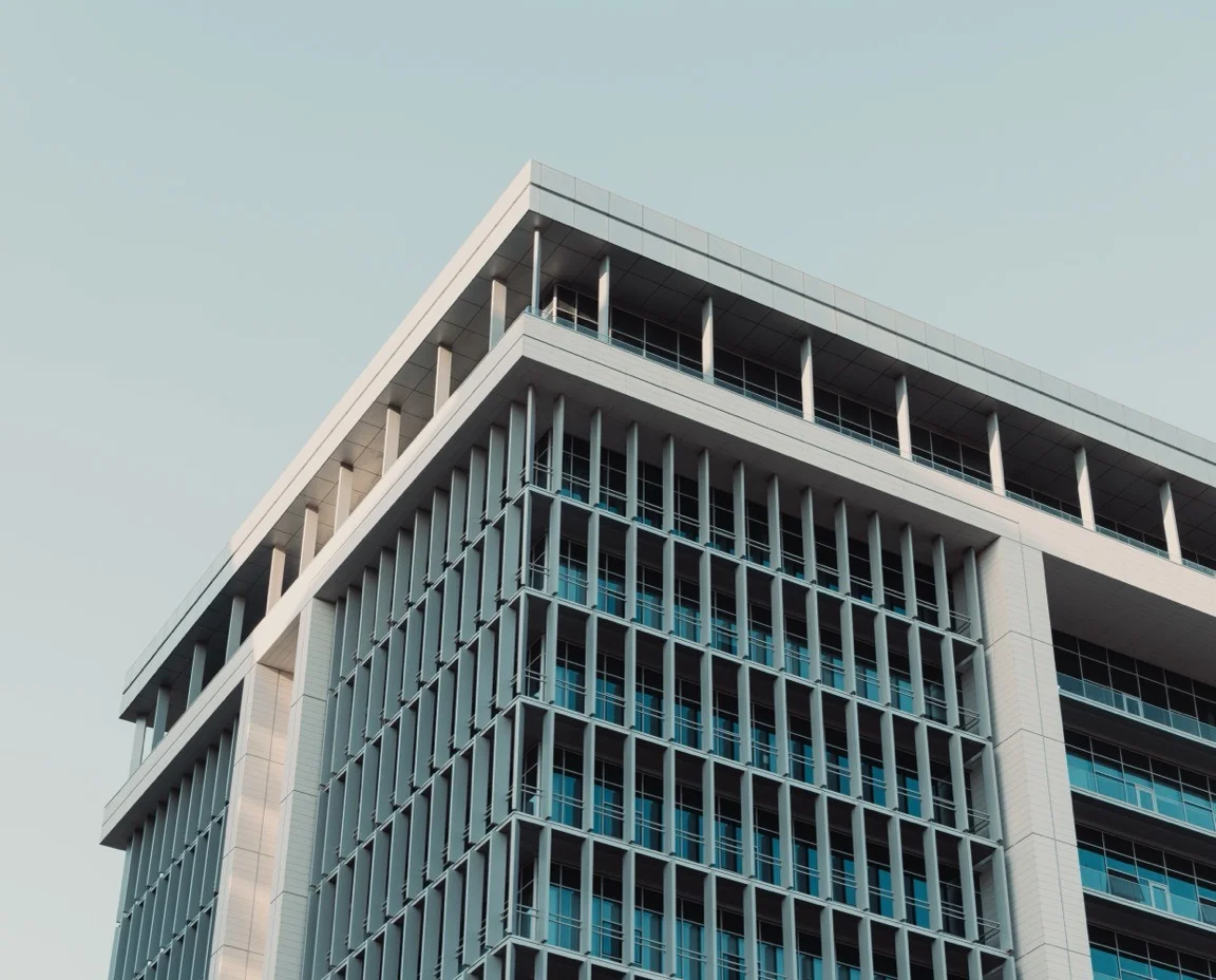 Glass facade of a modern commercial office building in daylight