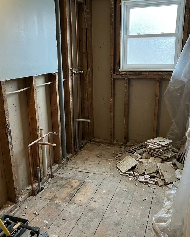 Bathroom stripped back to studs and subfloor mid-renovation