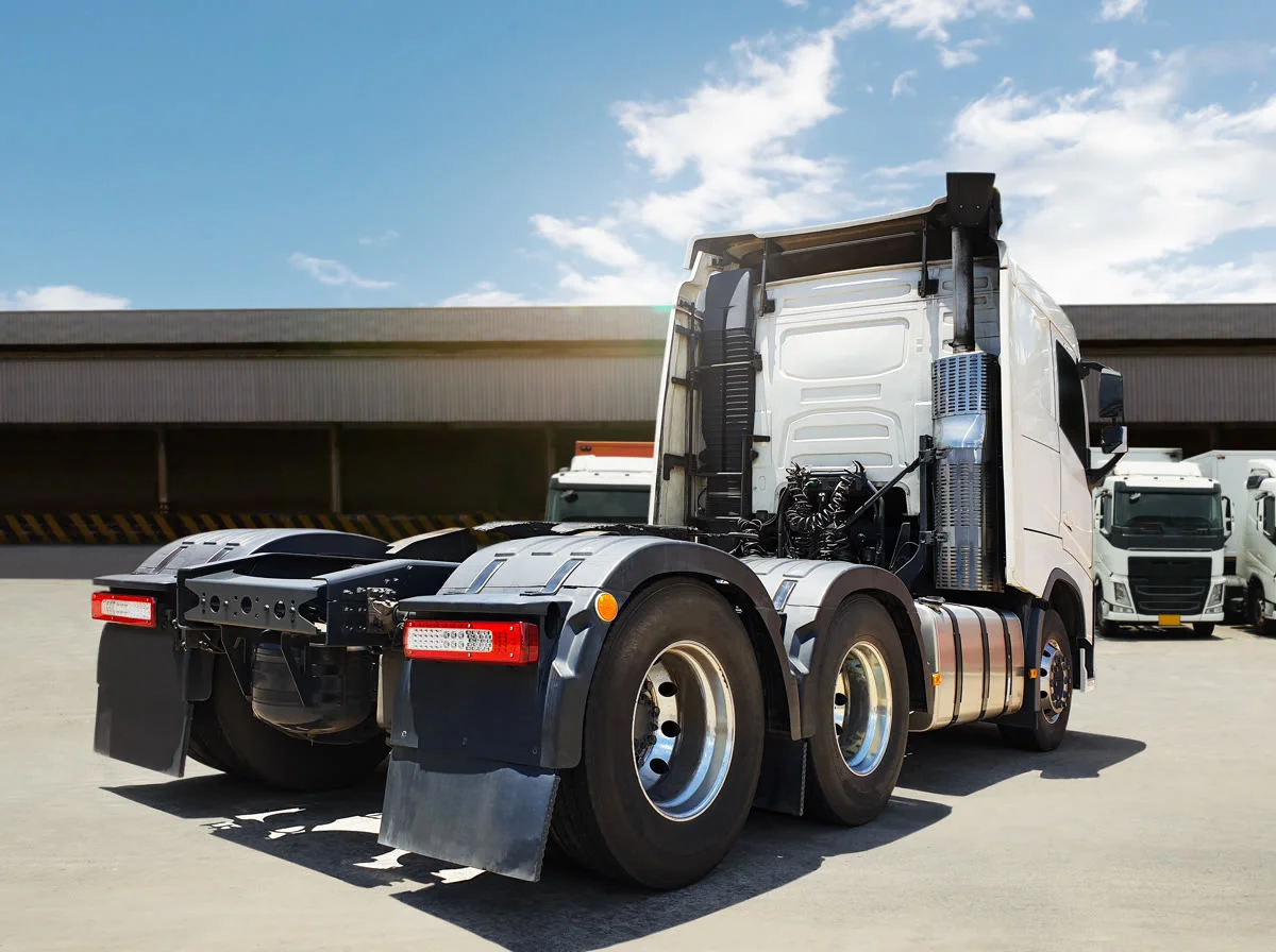 Tractor unit standing bobtail on a warehouse apron with no trailer coupled