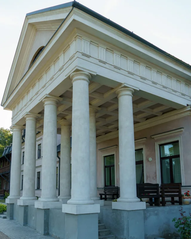 Stone portico with columns on a civic building, photographed from the steps